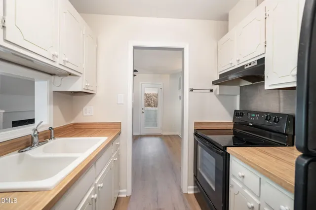 a kitchen with a stove and a refrigerator
