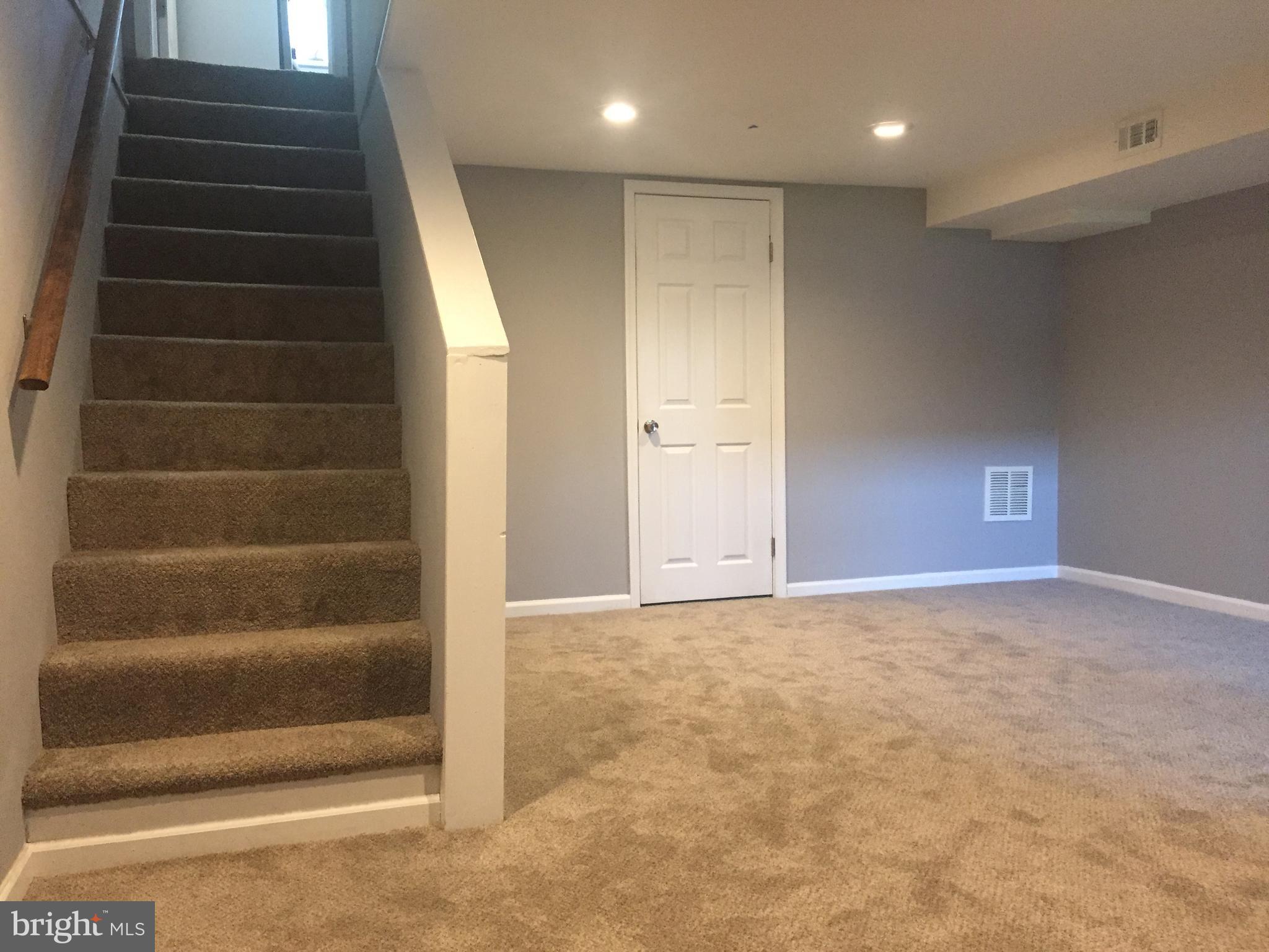1928 Jasmine Road Dundalk, MD 21222 - Photo 22 of 30 a view of an empty room with stairs