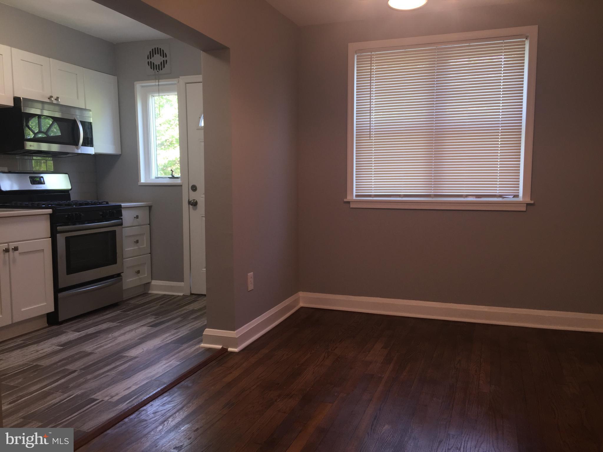 1928 Jasmine Road Dundalk, MD 21222 - Photo 6 of 30 a view of a kitchen with wooden floor and a window