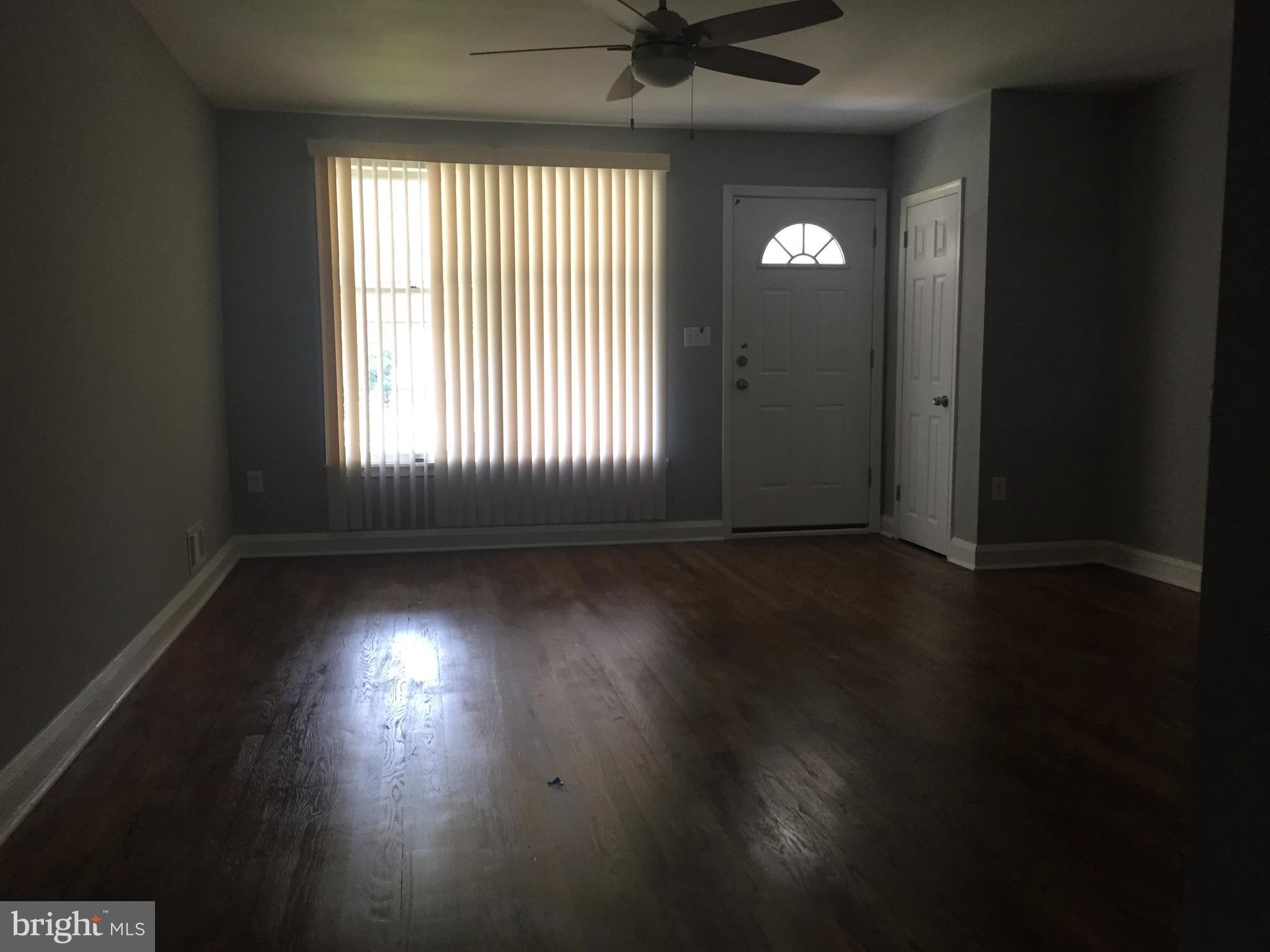 1928 Jasmine Road Dundalk, MD 21222 - Photo 8 of 30 an empty room with wooden floor and windows