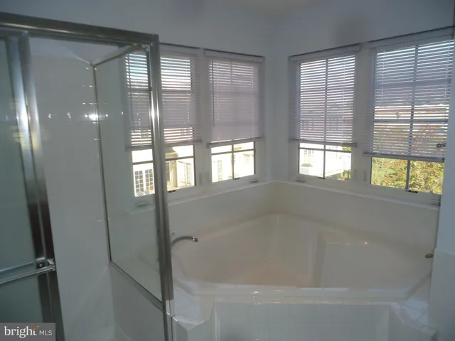 a bath tub sitting next to a window