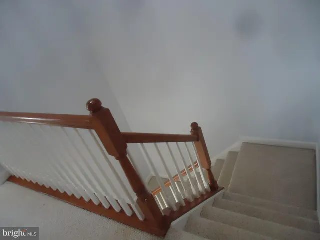 a view of staircase with white walls