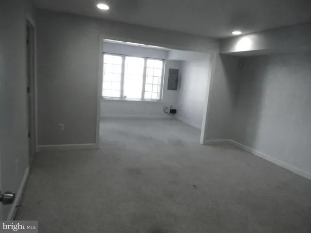 an empty room with a windows and closet