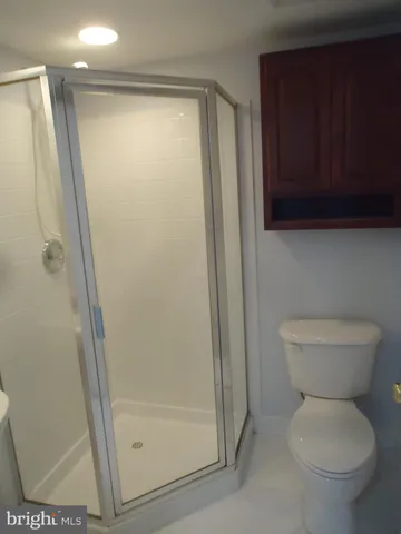 a bathroom with a toilet and a shower