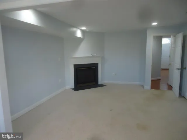 an empty room with a fireplace
