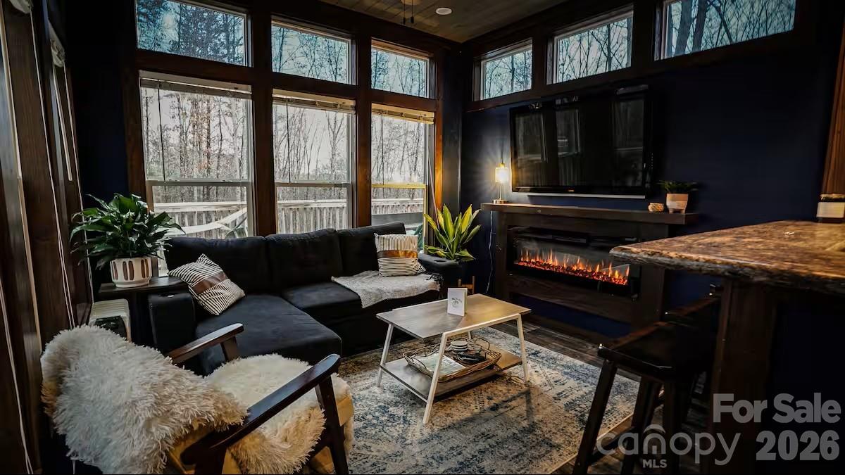 221 Summerfield Lane Rutherfordton, NC 28139 - Photo 3 of 33 a living room with furniture a flat screen tv and a floor to ceiling window