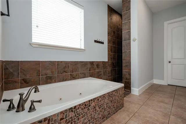a bathroom with a bathtub and a shower