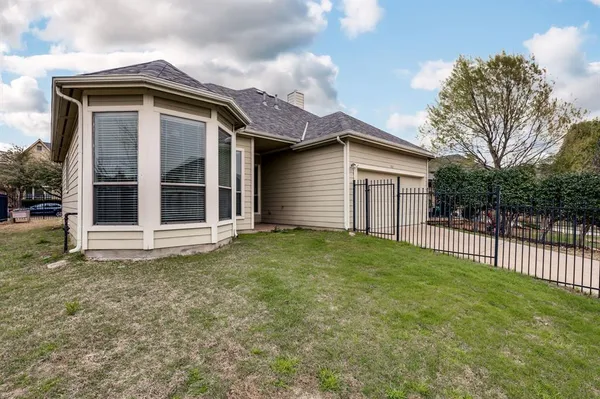 a front view of a house with a garden and garage