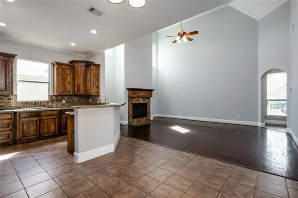 a kitchen with granite countertop a stove a sink and a microwave