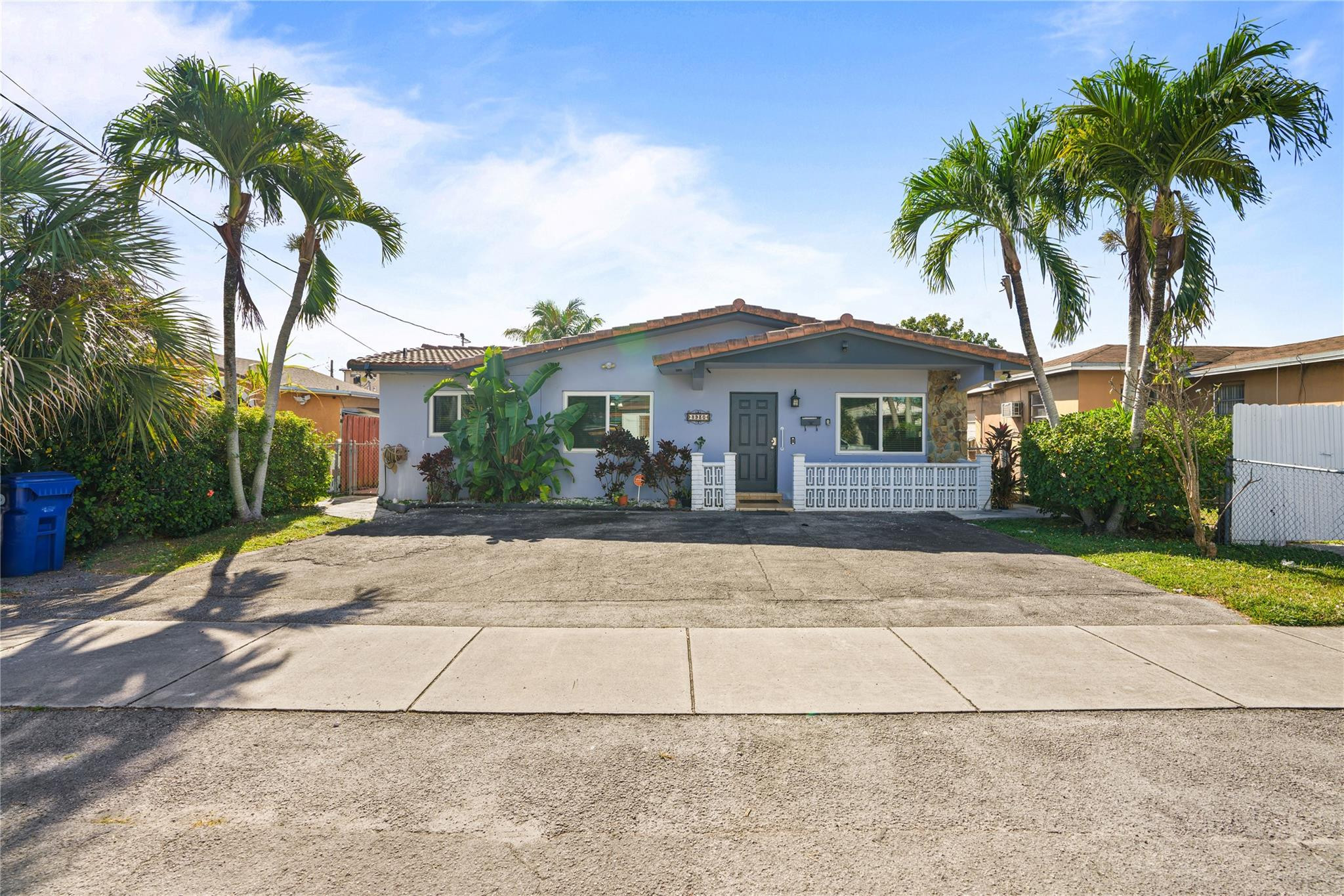 a front view of a house with a yard and a garage
