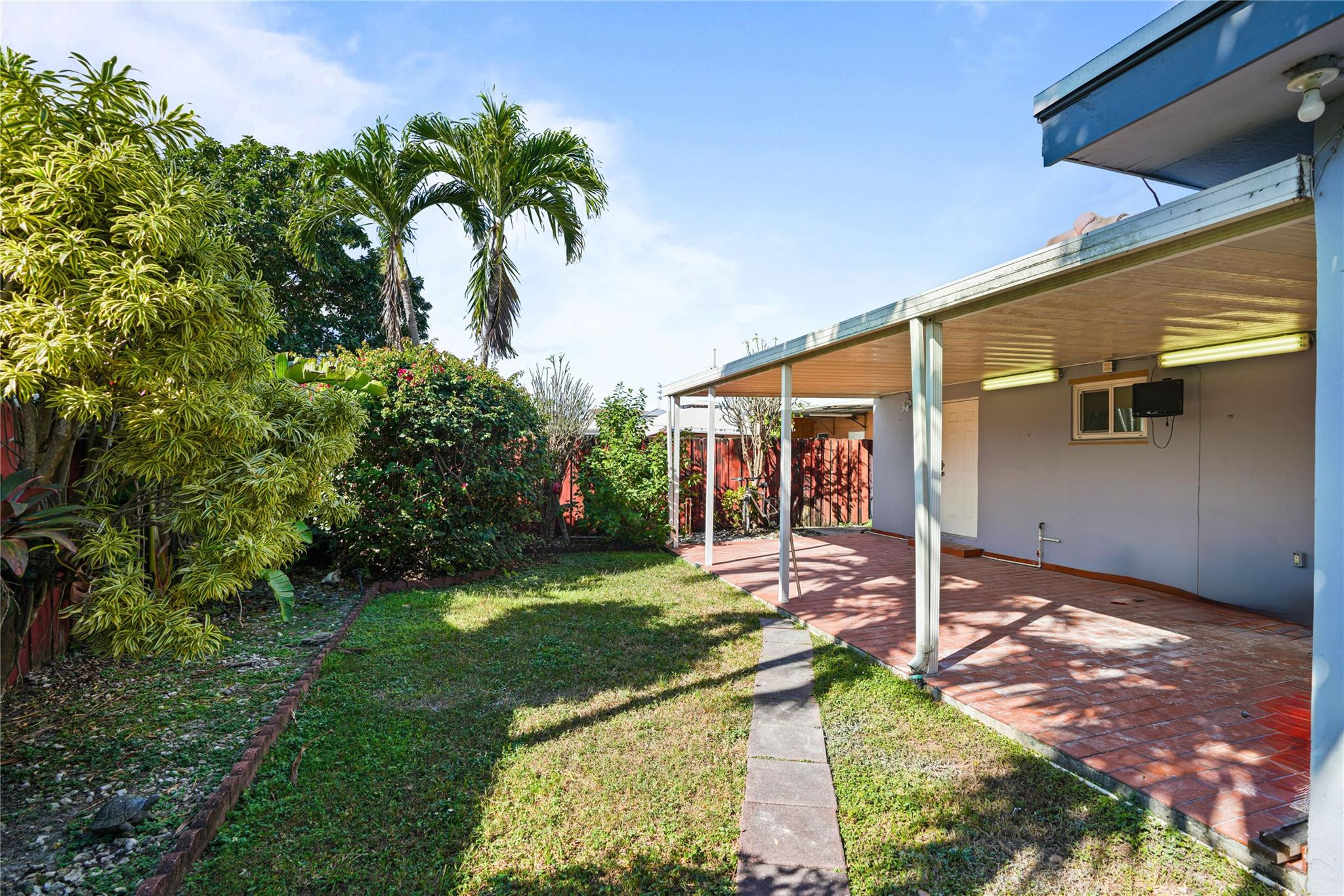 8930 Southwest 38th Street Miami, FL 33165 - Photo 15 of 16 a front view of a house with garden