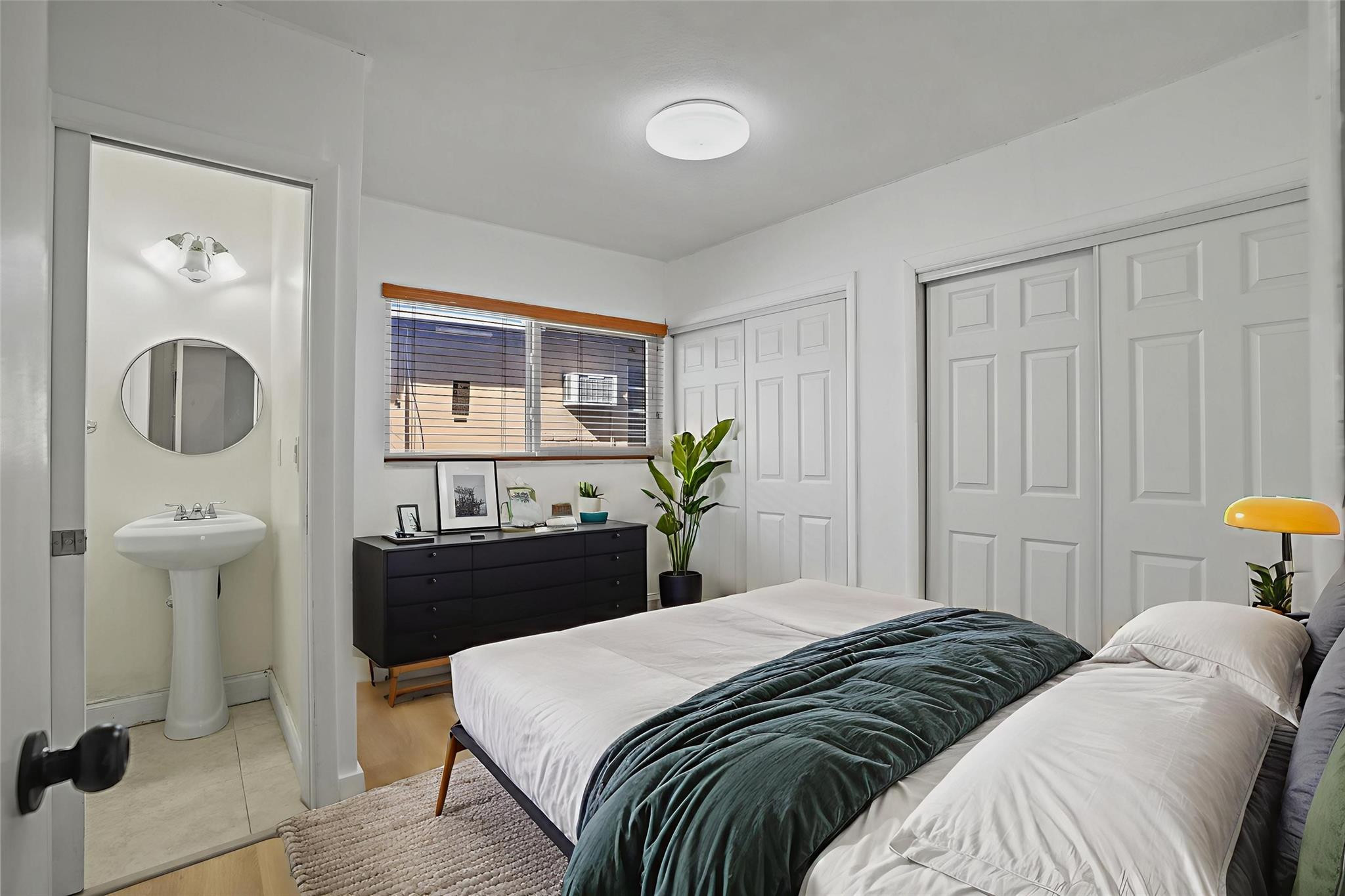 8930 Southwest 38th Street Miami, FL 33165 - Photo 6 of 16 a bedroom with a bed and mirror