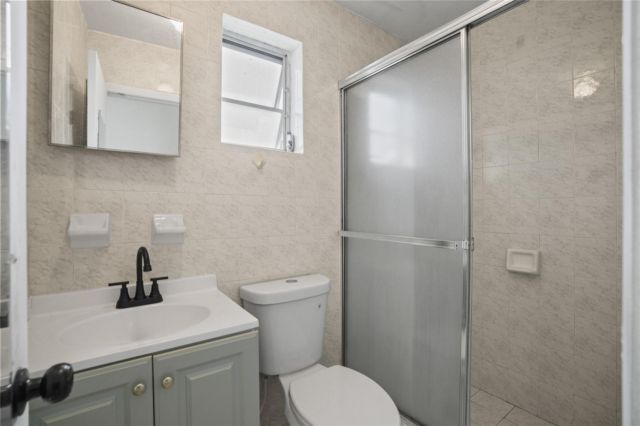 8930 Southwest 38th Street Miami, FL 33165 - Photo 7 of 16 a bathroom with a toilet a sink and shower