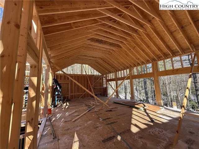 a couple of table and chairs in front of house