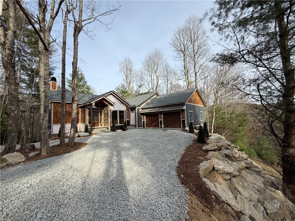 Boulder Creek Drive Boone, NC 28607 - Photo 3 of 32 a front view of a house with a yard and garage