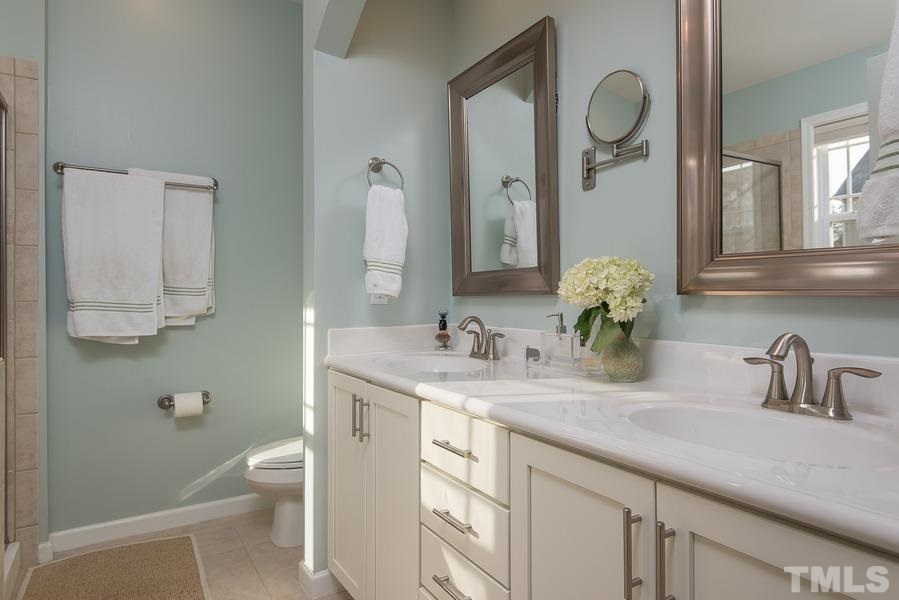 1520 Crafton Way Raleigh, NC 27607 - Photo 14 of 22 a bathroom with a granite countertop sink a toilet and mirror