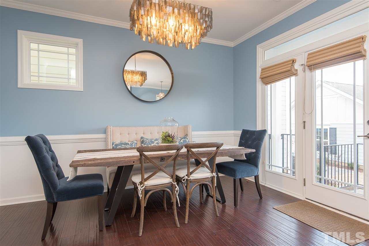 1520 Crafton Way Raleigh, NC 27607 - Photo 7 of 22 a view of a dining room with furniture wooden floor and a chandelier