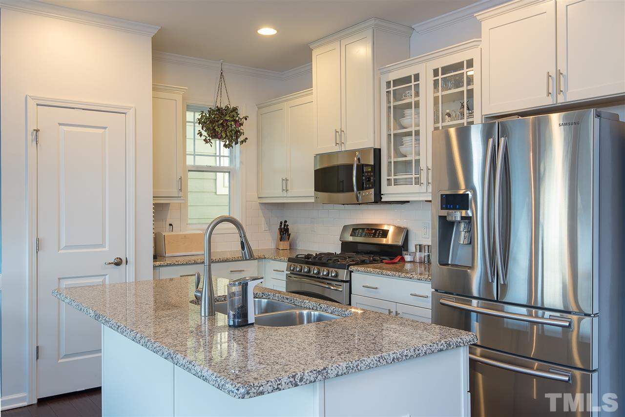 1520 Crafton Way Raleigh, NC 27607 - Photo 8 of 22 a kitchen with granite countertop a refrigerator and a sink