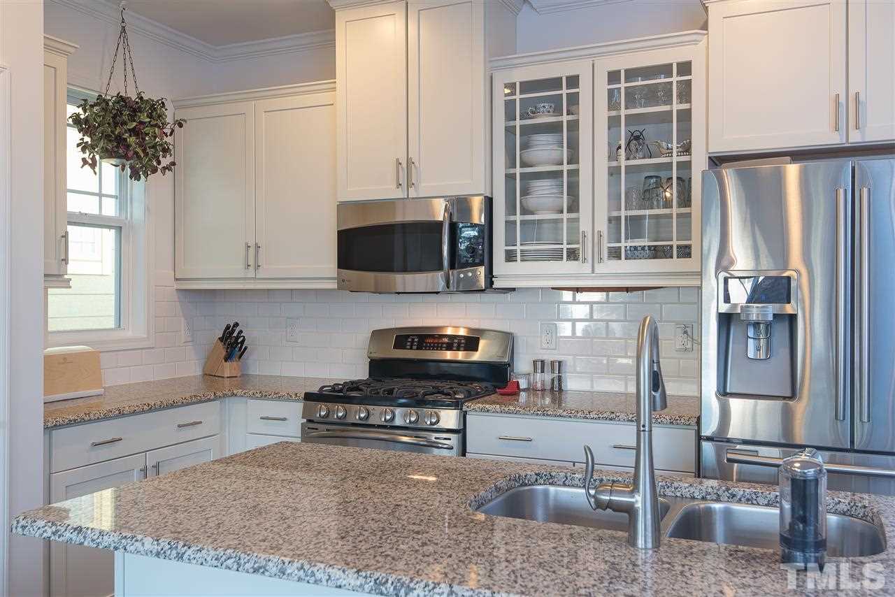 1520 Crafton Way Raleigh, NC 27607 - Photo 9 of 22 a kitchen with stainless steel appliances granite countertop a stove a sink and a microwave