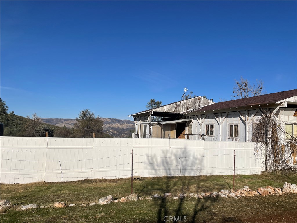 4747 Bear Valley Road Mariposa, CA 95338 - Photo 6 of 7 a view of a white house with a big yard