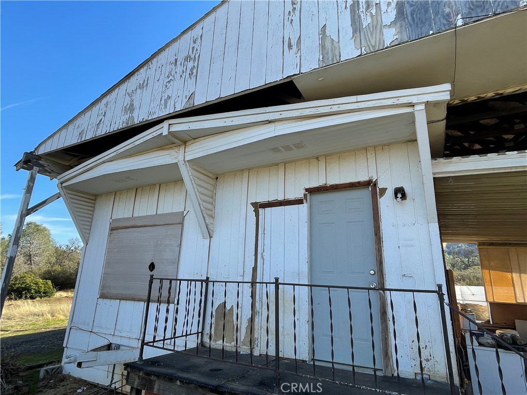 4747 Bear Valley Road Mariposa, CA 95338 - Photo 7 of 7 a view of a wooden house with a large window