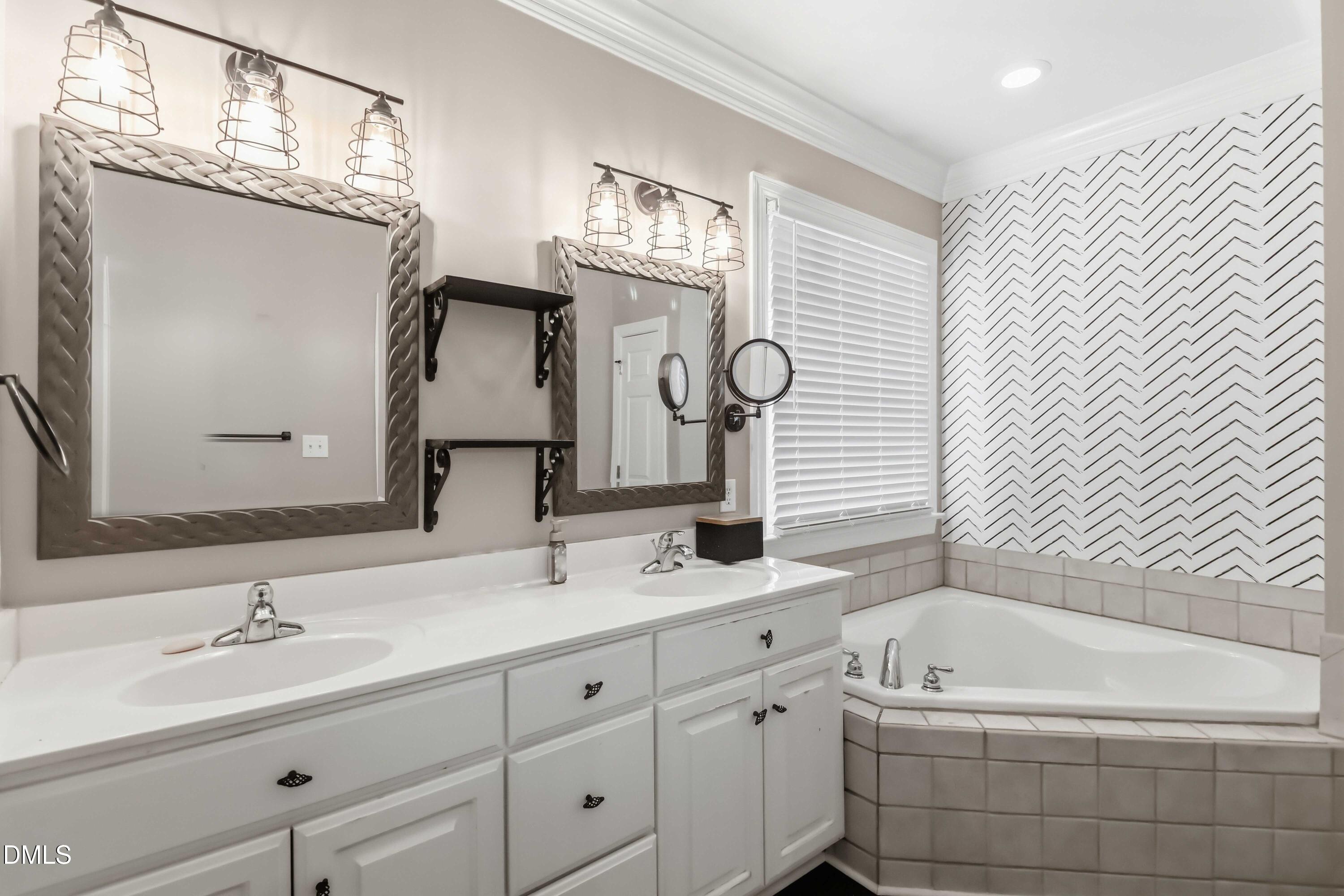 226 Fletcher Ridge Road Timberlake, NC 27583 - Photo 14 of 30 a bathroom with a double vanity sink mirror and bathtub