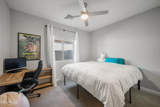 a bedroom with a bed and a desk