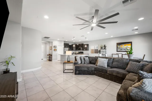 a living room with furniture and kitchen view