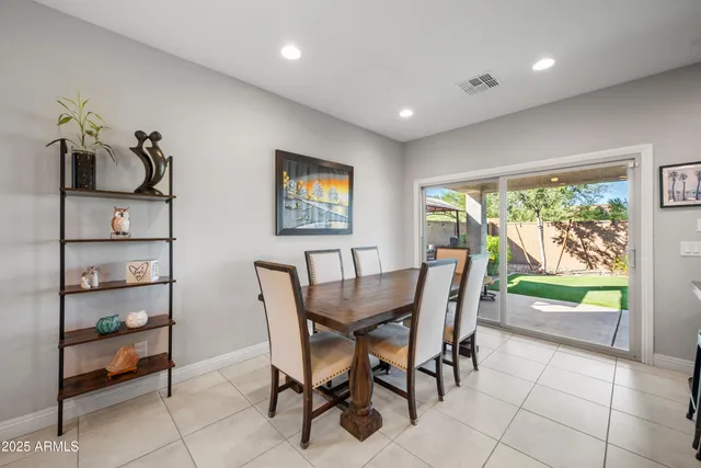 a dining room with furniture and a floor to ceiling window