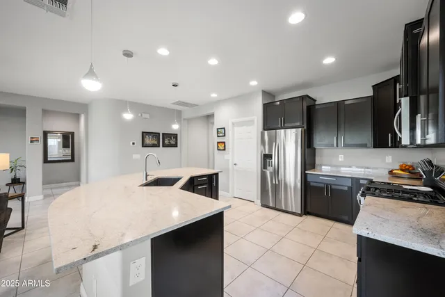 a kitchen with refrigerator and cabinets