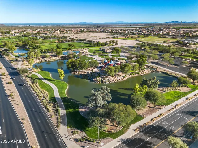 an aerial view of a city with lots of residential buildings and ocean view in back