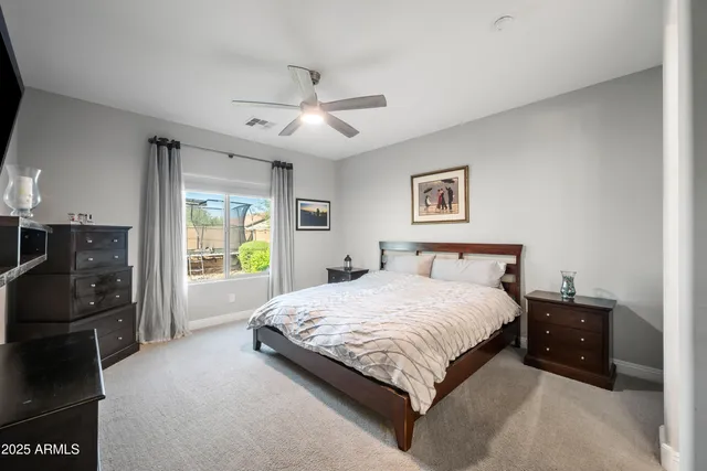 a bedroom with a bed dresser and a window