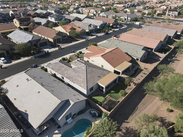 an aerial view of a house with a swimming pool and outdoor space