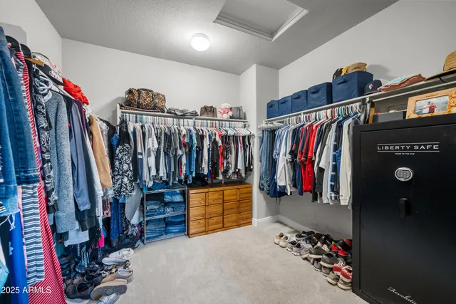 a view of walk in closet with clothes
