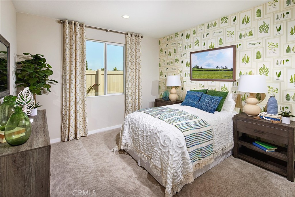 30934 Campania Road Highland, CA 92346 - Photo 12 of 19 a bedroom with a bed and a potted plant