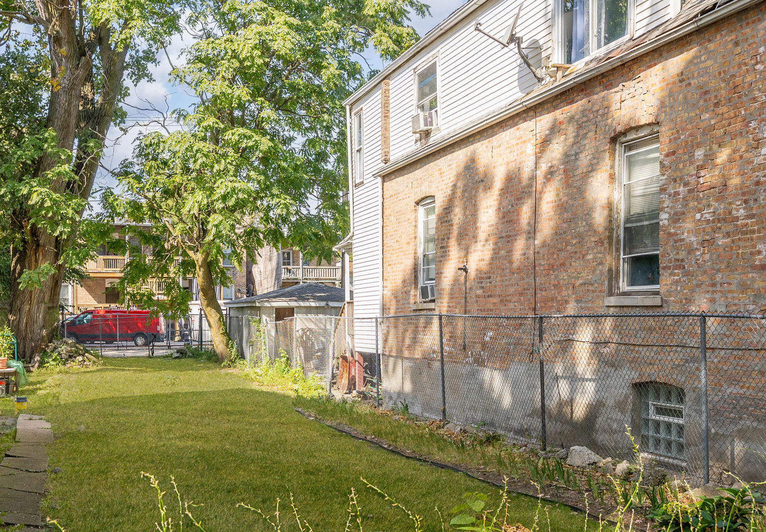 6124 South Sangamon Street Chicago, IL 60621 - Photo 14 of 17 front view of a building with a yard