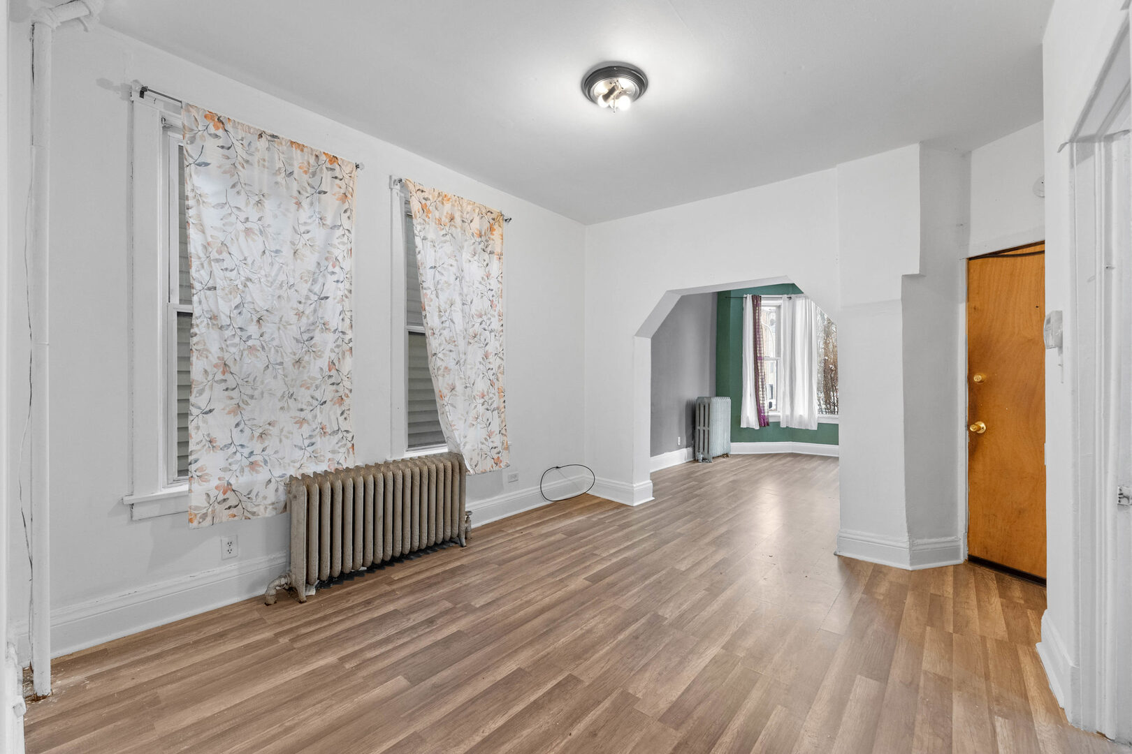 6124 South Sangamon Street Chicago, IL 60621 - Photo 2 of 17 wooden floor in an empty room with a window
