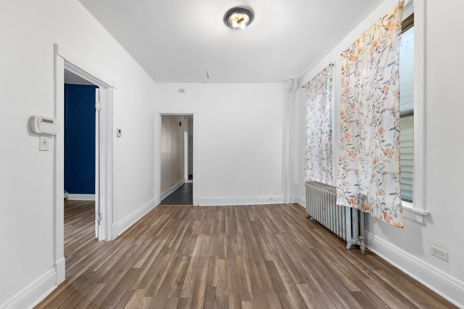 6124 South Sangamon Street Chicago, IL 60621 - Photo 4 of 17 a view of empty room with wooden floor