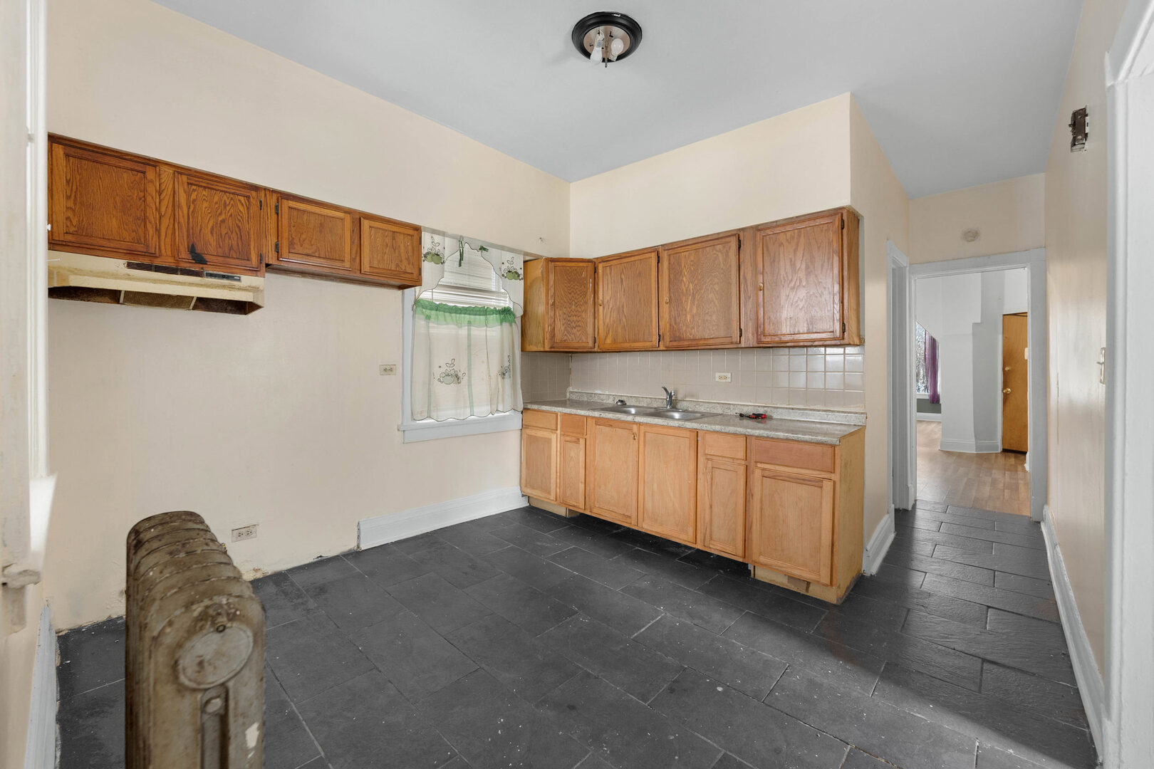 6124 South Sangamon Street Chicago, IL 60621 - Photo 7 of 17 a kitchen with cabinets a sink and a refrigerator