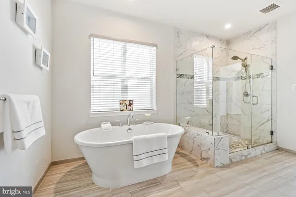 a white bath tub sitting next to a white sink