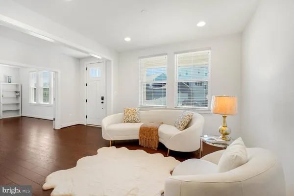 a living room with furniture and a lamp