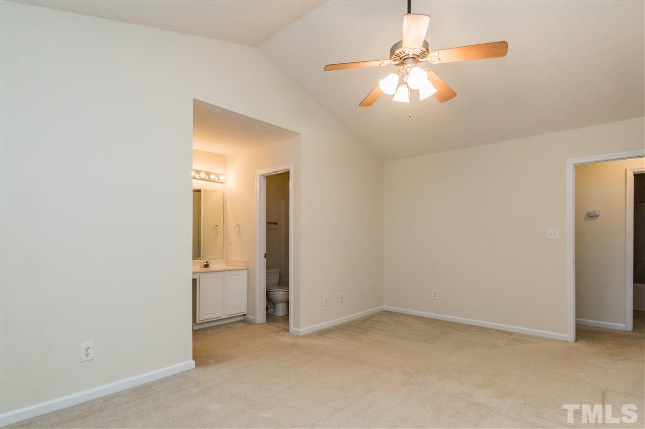 118 Setter Point Clayton, NC 27520 - Photo 13 of 21 an empty room with chandelier fan and closet area