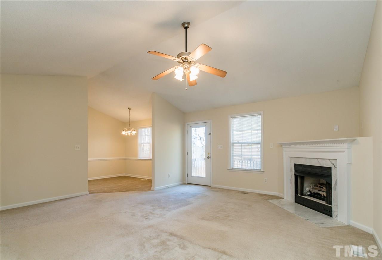 118 Setter Point Clayton, NC 27520 - Photo 4 of 21 a view of an empty room with a fireplace and a window