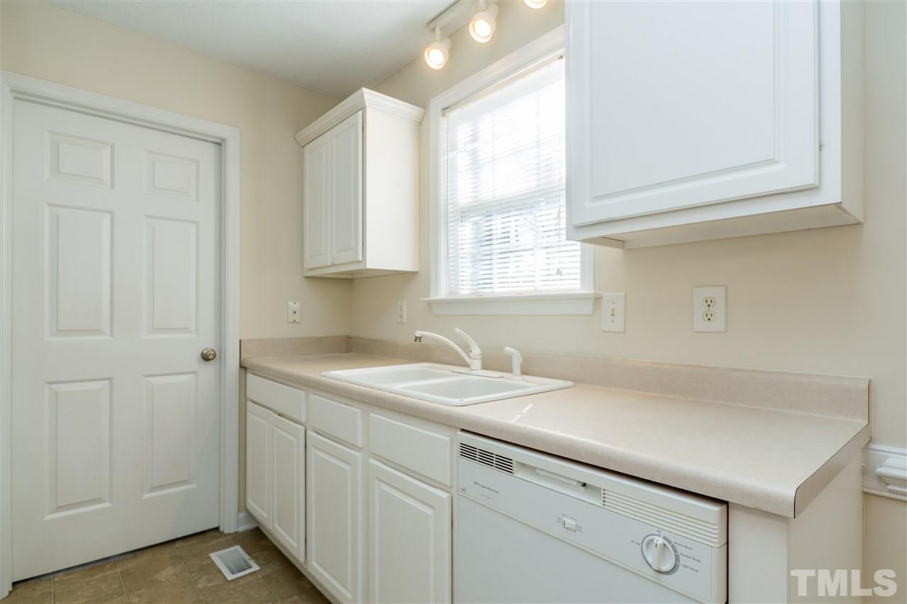 118 Setter Point Clayton, NC 27520 - Photo 7 of 21 a utility room with cabinets washer and dryer