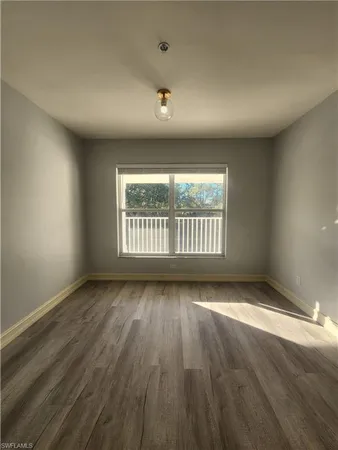 a kitchen with granite countertop a refrigerator and a stove top oven
