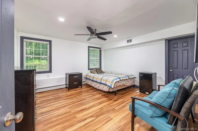 a bathroom with a granite countertop sink a toilet and a mirror