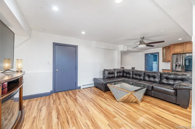 a bathroom with a granite countertop toilet a sink a mirror a window and a shower