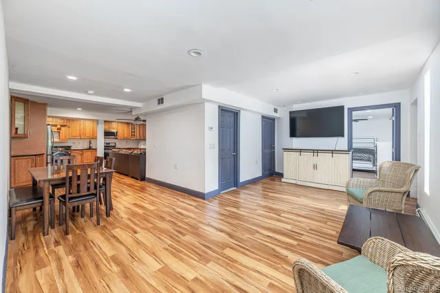 a view of a livingroom with wooden floor and a rug