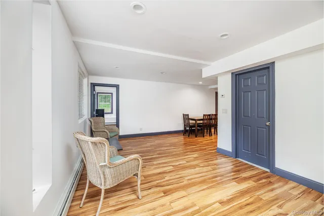 a living room with furniture and kitchen view