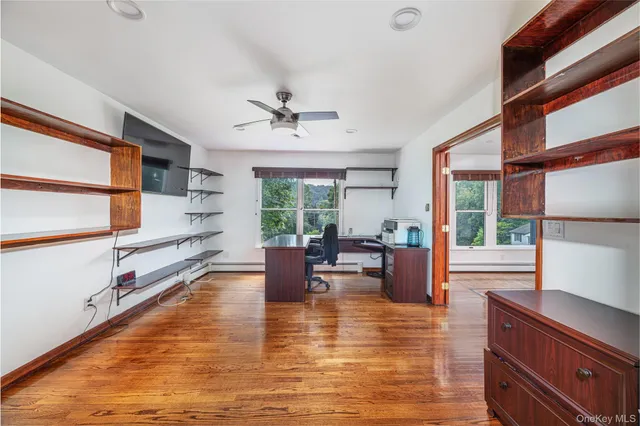 a workspace with furniture window and wooden floor